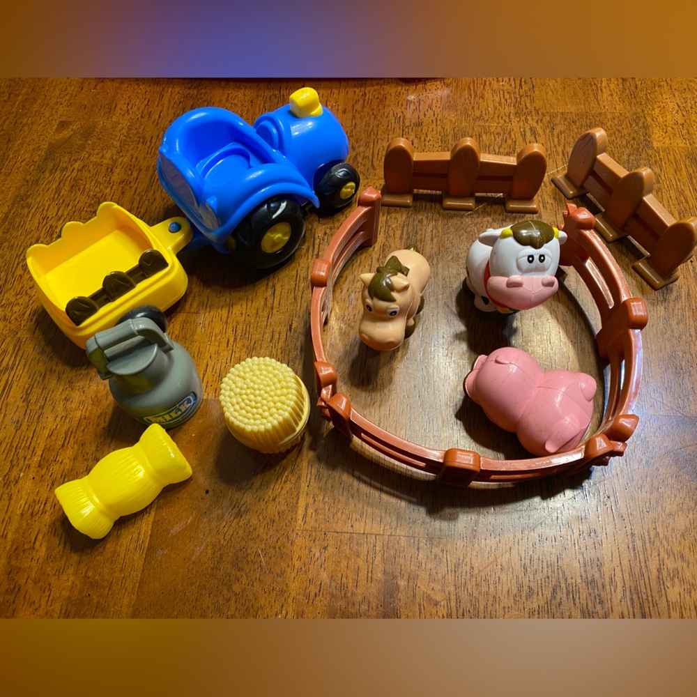 Farm animals, tractor and wagon, hay bales and some fencing.